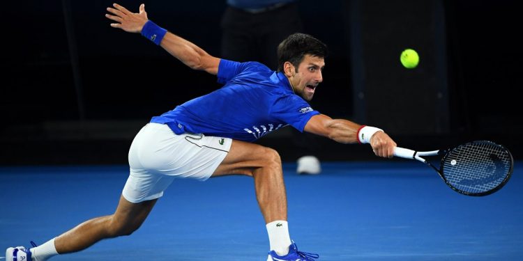 Novak Djokovic reaches for a shot during his match against Daniil Medvedev (not in pic) in Melbourne, Monday