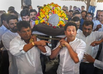 Former Indian cricketer Sachin Tendulkar attends the funeral procession of his coach Ramakant Achrekar, in Mumbai