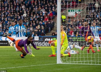 Raheem Sterling looks on as his diving header finds the back of the net to double Man City’s lead at Huddersfield Town, Sunday