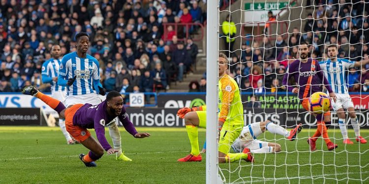 Raheem Sterling looks on as his diving header finds the back of the net to double Man City’s lead at Huddersfield Town, Sunday