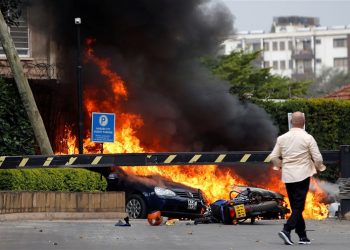 Cars on fire at the hotel compound in Nairobi where explosions and gunshots were heard, Tuesday