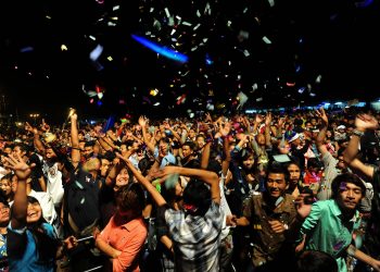 People celebrate the first public countdown to the New Year in Yangon on December 31. Some 50,000 people were expected to gather at the revered golden Shwedagon Pagoda in Yangon for the city's first public countdown to the New Year and fireworks. (AFP)