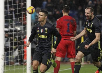 Cristiano Ronaldo (L) celebrates with his teammate Giorgio Chiellini after scoring Juventus's second goal during the Serie A match against Lazio at the Olympic stadium