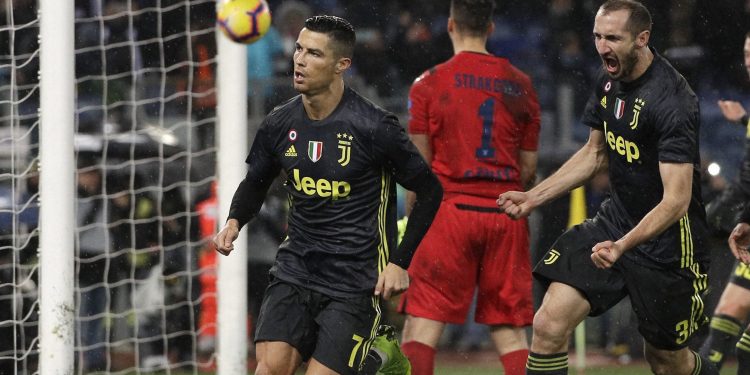 Cristiano Ronaldo (L) celebrates with his teammate Giorgio Chiellini after scoring Juventus's second goal during the Serie A match against Lazio at the Olympic stadium