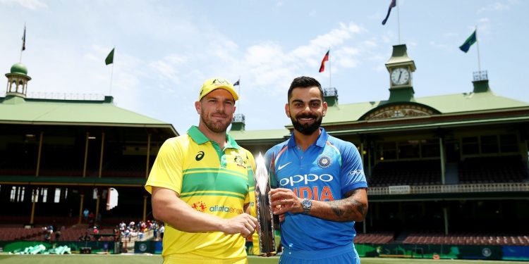 Indian skipper Virat Kohli (R) and his Australian counterpart Aaron Finch pose with the ODI trophy at the SCG, Friday