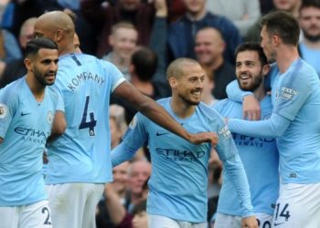 Manchester City players celebrate after scoring a goal against Burnley