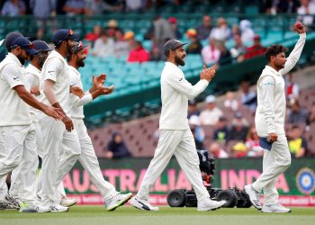 Kuldeep Yadav (R) reacts as he walks off the ground with captain Virat Kohli (2nd R) and teammates after taking five wickets during the fourth day's play of the fourth Test against Australia at the Sydney Cricket Ground