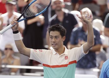 Kei Nishikori waves at the crowd after he won his semifinal match against Jeremy Chardy at the Brisbane International tennis tournament