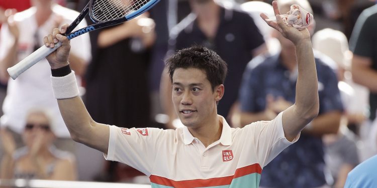 Kei Nishikori waves at the crowd after he won his semifinal match against Jeremy Chardy at the Brisbane International tennis tournament