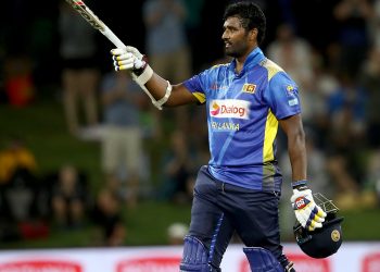 Thisara Perera raises his bat after reaching century against New Zealand, Saturday