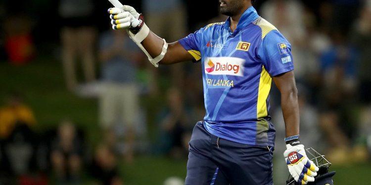 Thisara Perera raises his bat after reaching century against New Zealand, Saturday