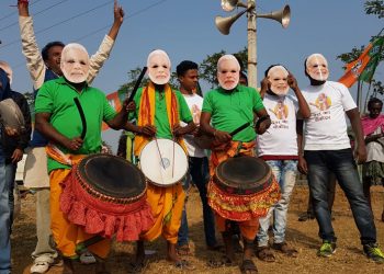 People decked up in colorful attire and Narendra Modi masks to welcome the PM in Bolangir, Tuesday