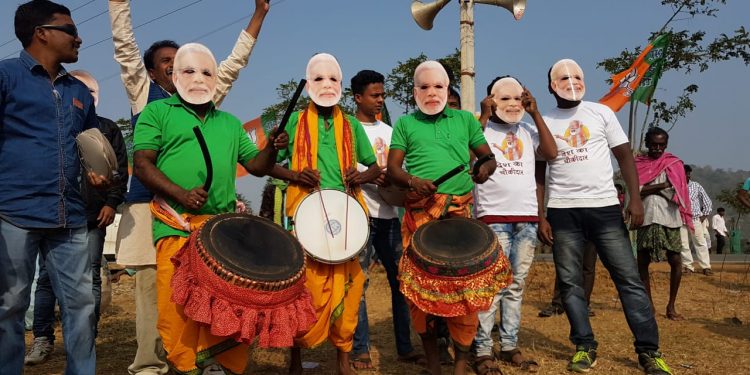 People decked up in colorful attire and Narendra Modi masks to welcome the PM in Bolangir, Tuesday