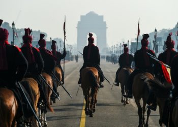 Members of the President's Bodyguard regiment ride towards the India Gate monument during rehearsals for the upcoming Republic Day