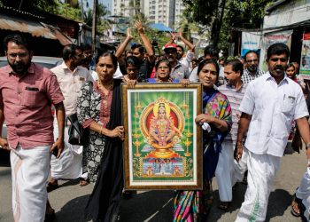 Protesters hold a portrait of Hindu deity “Ayappa” as they take part in a rally called by various Hindu organisations after two women entered the Sabarimala temple, in Kochi, India, January 2, 2019. REUTERS/Sivaram V