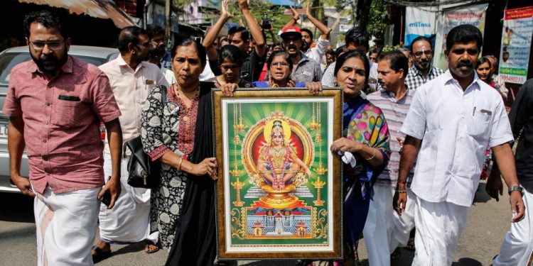 Protesters hold a portrait of Hindu deity “Ayappa” as they take part in a rally called by various Hindu organisations after two women entered the Sabarimala temple, in Kochi, India, January 2, 2019. REUTERS/Sivaram V