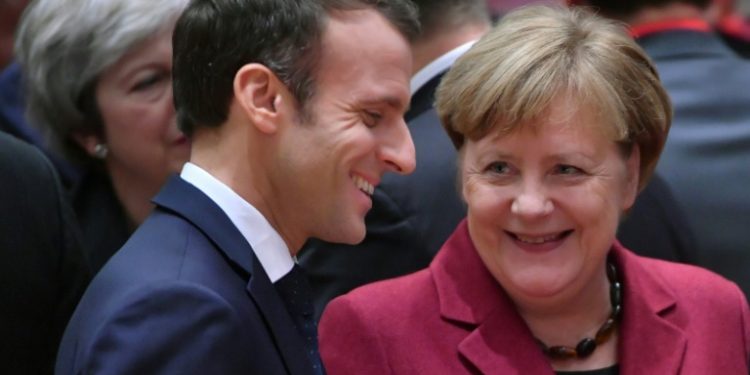 France's President Emmanuel Macron (L) talks with Germany's Chancellor Angela Merkel want to strengthen ties betweeen their two countries (EMMANUEL DUNAND)