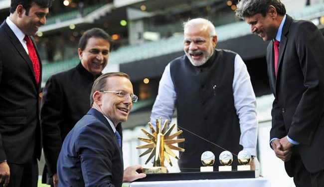 Narendra Modi (2nd from right) laughs with former Indian cricketers (L-R) V. V. S. Laxman, Sunil Gavaskar and Kapil Dev after they presented Australian Prime Minister Tony Abbott with a gift during a reception in Melbourne. (PTI)