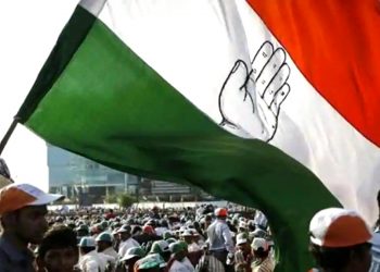 A supporter of Congress waves a flag at a Congress Rally (PTI)