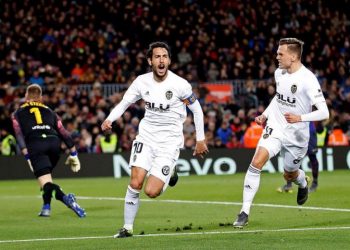 Valencia's Dani Parejo (C) celebrates with Denis Cheryshev (R) after giving his team a 2-0 lead against FC Barcelona during their La Liga match at Camp Nou stadium in Barcelona, Spain, on Feb. 2, 2019. (AP)