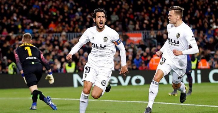 Valencia's Dani Parejo (C) celebrates with Denis Cheryshev (R) after giving his team a 2-0 lead against FC Barcelona during their La Liga match at Camp Nou stadium in Barcelona, Spain, on Feb. 2, 2019. (AP)