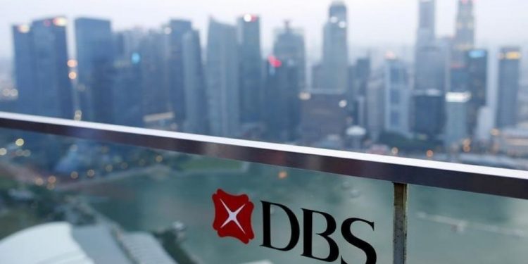 A DBS logo in pictured in the backdrop of the central business district in Singapore (Reuters)