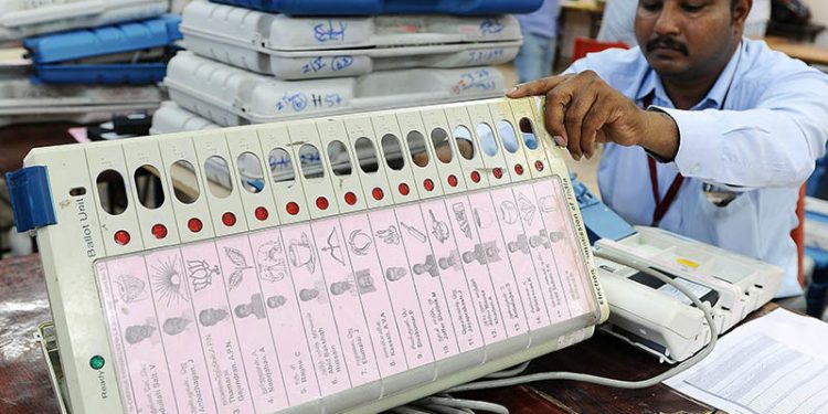 Polling officials pasting candidates list along with photos and party symbols in Electronic Voting Machines(EVM) at distribution centre at NKT National Girls Higher Secondary School  in Chennai for Tamil Nadu Assembly elections.10-05-2016 (PTI)