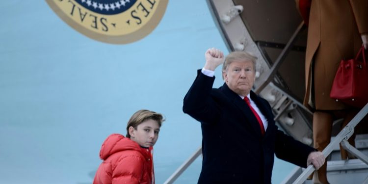 US President Donald Trump says he would not encouragae his son Barron, seen here boarding Air Force One with his father, to play American football (AFP)