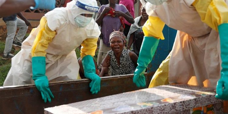 A mother of a child, suspected to have died from Ebola, cries near her coffin in Beni, North Kivu Province of DRC (Reuters)