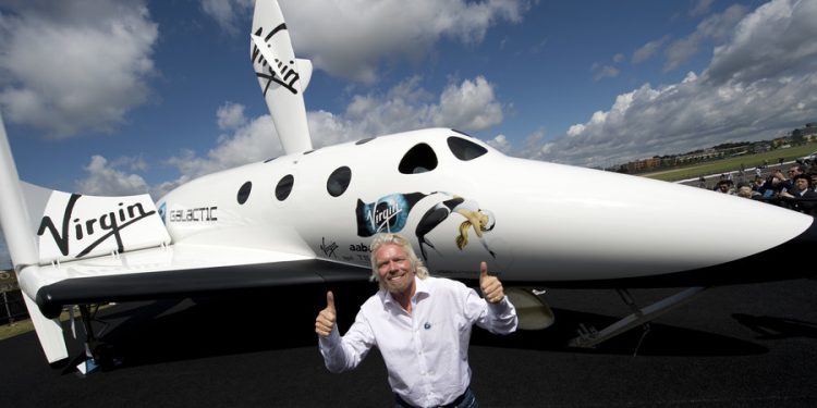 Virgin Galactic founder Sir Richard Branson (R) and Virgin Galactic CEO George Whitesides (C) receive a plaque from the Guinness Book of World Records for their RocketMotorTwo engine, that flew on Virgin Galactic's SpaceShipTwo "VSS Unity" into space on December 13, 2018, during a ceremony at the National Air and Space Museum in Washington, DC, on February 7, 2019. - The RocketMotorTwo is the engine that flew on Virgin Galactic's SpaceShipTwo "VSS Unity" into space December 13, 2018. AFP