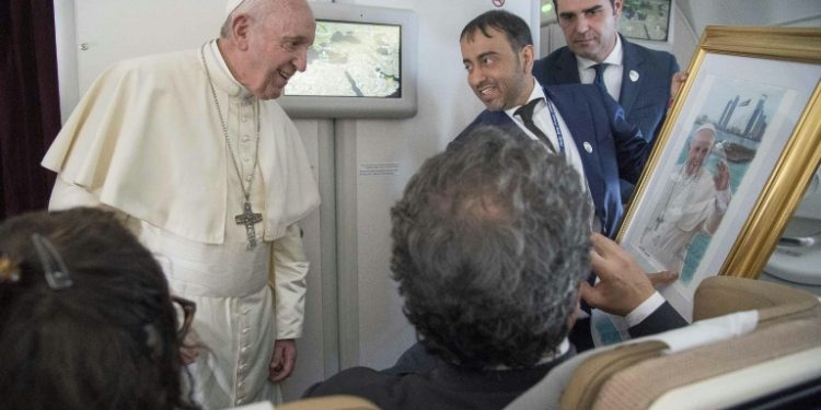 Pope Francis, shown here accepting a gift from an Arab journalist aboard the papal plane, said the problem of sexual abuse by priests could be found "anywhere" (AFP)