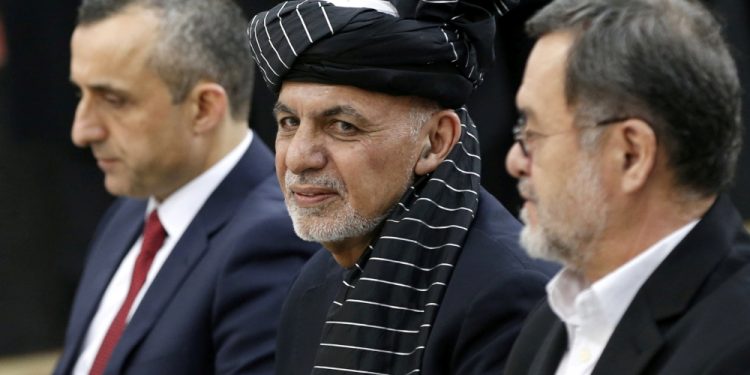 Afghan President Ashraf Ghani, alongside his two vice president candidates Amrullah Saleh, left, and Sarwar Danish, right, arrives to register as a candidate for presidential election at the Afghanistan Independent Election Commission (IEC) in Kabul in this Jan. 20, 2019 file photo (Reuters)