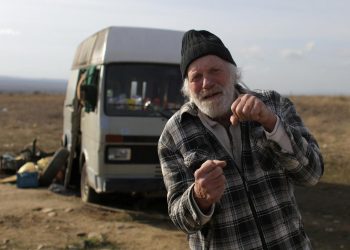 Former Dutch boxer Rudi Lubbers poses in front of the van where he and his partner were living for the last eight months, near the village of Kosharitsa, Bulgaria