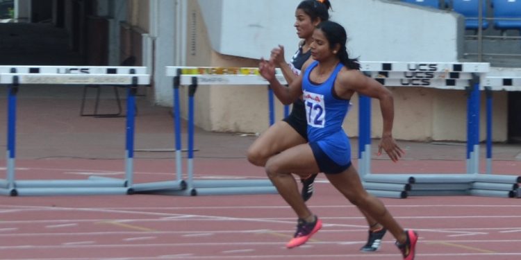 Dutee Chand (in blue) sprints during the women’s 200m event in New Delhi, Wednesday