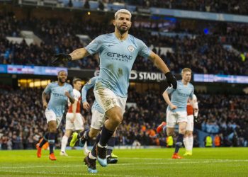 Manchester City’s Sergio Aguero wheels away in celebration after scoring one of his three goals against Arsenal, Sunday 