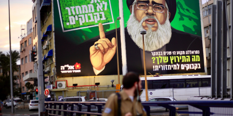 A billboard shows Hezbollah militant leader Hassan Nasrallah (AP)