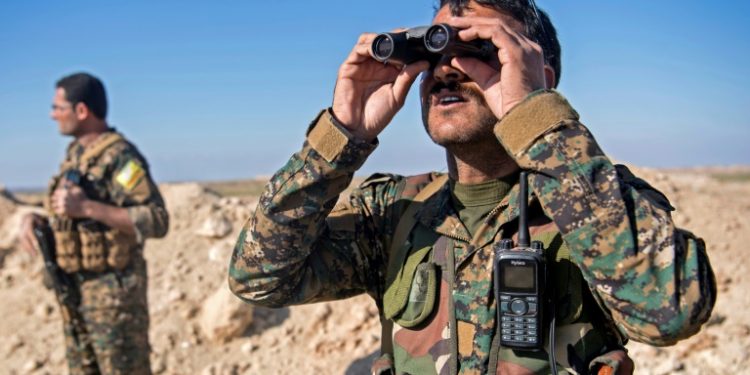 The SDF have built up a pair of sand embankments on a scrubby plateau overlooking Baghouz (AFP)