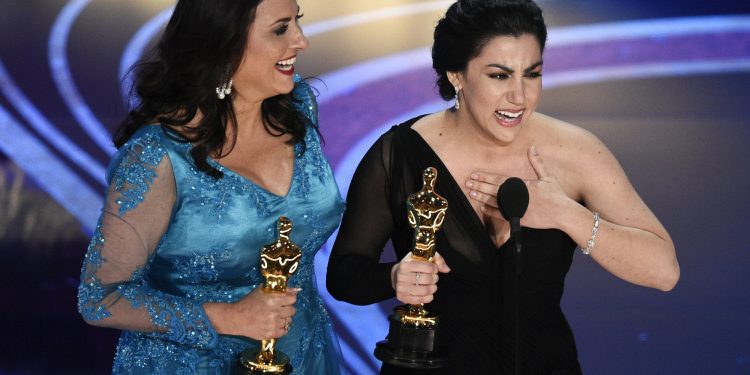 Melissa Berton, left, and Rayka Zehtabchi accept the award for best documentary short subject for "Period. End of Sentence." at the Oscars on Sunday, Feb. 24, 2019, at the Dolby Theatre in Los Angeles. (AP)