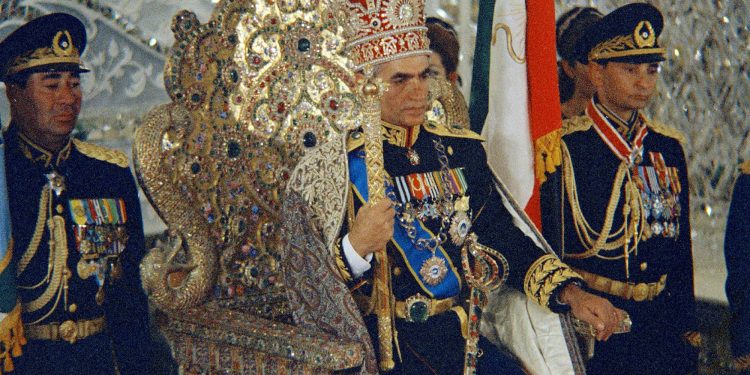 FILE - In this October 1967 file photo, Shah Mohammad Reza Pahlavi sits on the Peacock Throne in Tehran, Iran. Forty years ago, Iran's ruling shah left his nation for the last time and an Islamic Revolution overthrew the vestiges of his caretaker government. The effects of the 1979 revolution, including the takeover of the U.S. Embassy in Tehran and ensuing hostage crisis, reverberate through decades of tense relations between Iran and America. (AP)