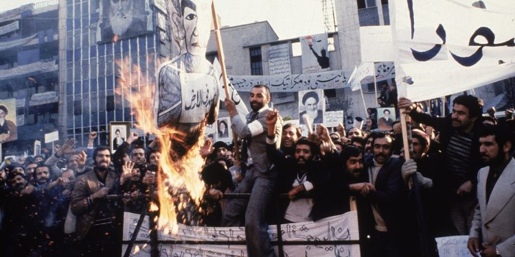 FILE - In an undated photo from 1979, protestors burn an effigy of Shah Mohammad Reza Pahlavi during a demonstration in front of the U.S. Embassy in Tehran, Iran. Forty years ago, Iran's ruling shah left his nation for the last time and an Islamic Revolution overthrew the vestiges of his caretaker government. The effects of the 1979 revolution, including the takeover of the U.S. Embassy in Tehran and ensuing hostage crisis, reverberate through decades of tense relations between Iran and America. (AP)