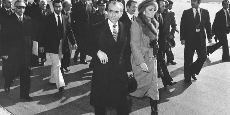 FILE - In this Jan. 16, 1979 file photo, Shah Mohammad Reza Pahlavi and Empress Farah walk on the tarmac at Mehrabad Airport in Tehran, Iran, to board a plane to leave the country. Forty years ago, Iran's ruling shah left his nation for the last time and an Islamic Revolution overthrew the vestiges of his caretaker government. The effects of the 1979 revolution, including the takeover of the U.S. Embassy in Tehran and ensuing hostage crisis, reverberate through decades of tense relations between Iran and America. (AP)