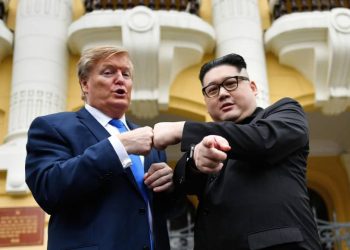 U.S. President Donald Trump impersonator Russel White and North Korean leader Kim Jong Un impersonator Howard X pose together for photographs outside the Opera House in Hanoi Friday. (AFP)