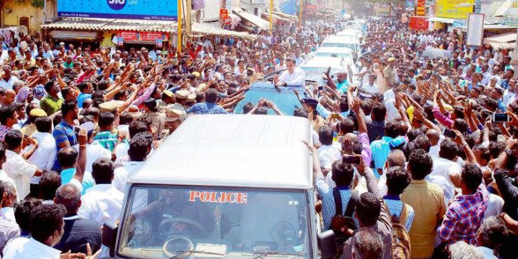 Actor-turned-politician Kamal Haasan greets supporters during a public rally to launch his party, at Raj Mahal in Tamil Nadu’s Pollachi Feb 21, 2018. (IANS)
