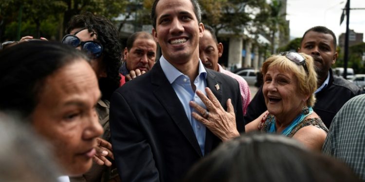 Venezuelan opposition leader and self declared acting president Juan Guaido greets supporters at a demonstration called by supporters in the transportation sector, in Caracas February 20, 2019 (AFP)