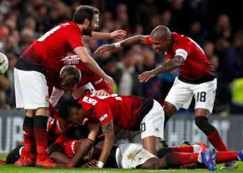 Manchester United players celebrate after Paul Pogba's goal against Chelsea, Monday