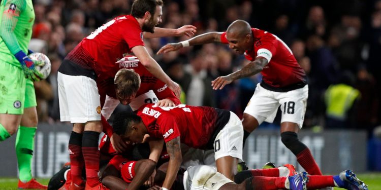 Manchester United players celebrate after Paul Pogba's goal against Chelsea, Monday