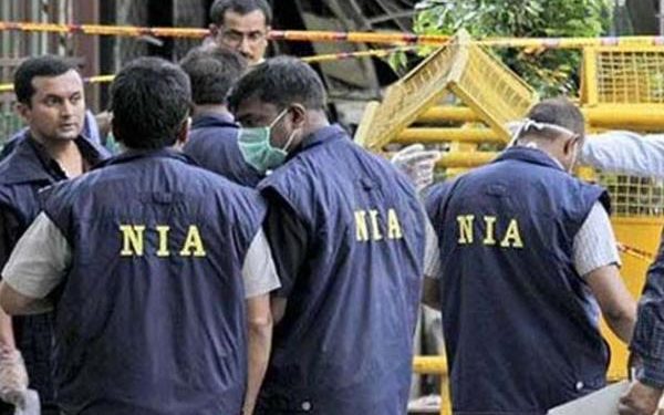 NIA personnel investigating the attack site (PTI)