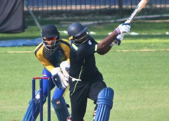 Suryakant Pradhan hits a six against Karnataka in Cuttack, Thursday   