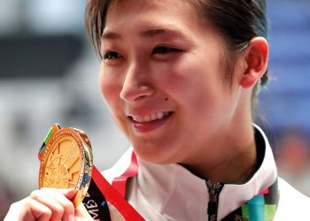 Japan’s Rikako Ikee holds up her gold medal after winning the women’s 100m butterfly final at the Asian Games. Ikee has finished with eight medals in total at the games. (AP)