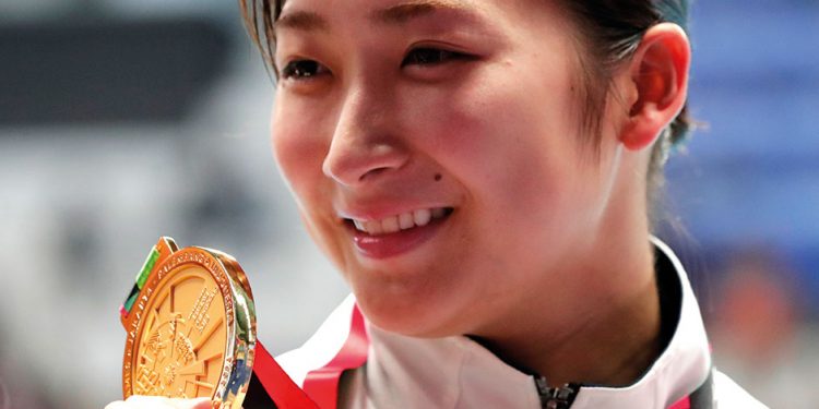 Japan’s Rikako Ikee holds up her gold medal after winning the women’s 100m butterfly final at the Asian Games. Ikee has finished with eight medals in total at the games. (AP)